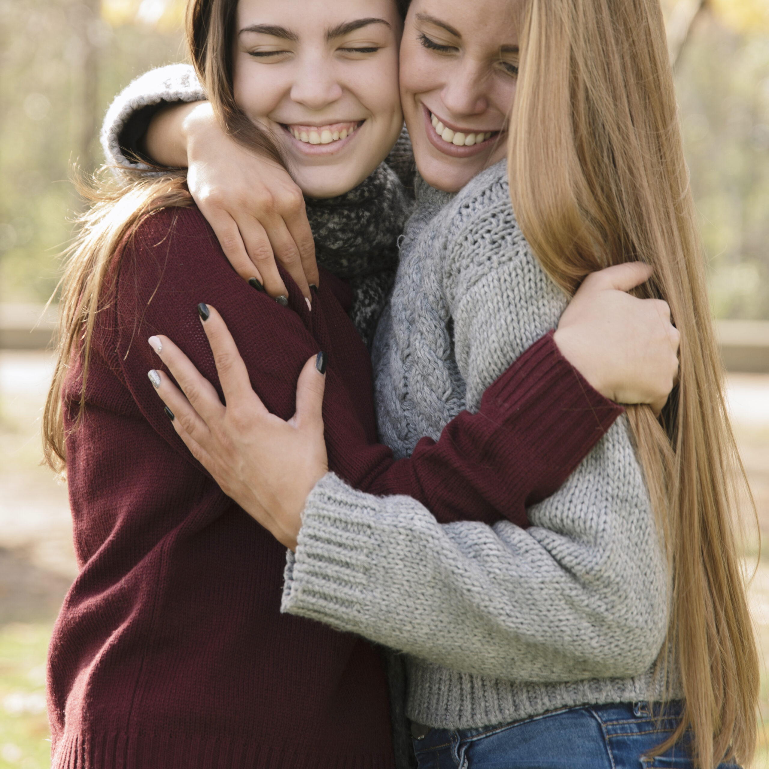 close-up-two-hugging-young-women-park